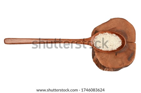 White rice in a wooden spoon isolated on white background