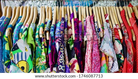 Close up of amazing colourful summer dresses hanging on rack