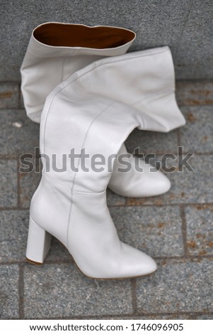 Footwear. Boots. Shoes for autumn and spring. Style and . fashion. Boots on the street. White and maroon. High quality photo
