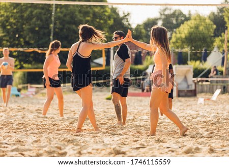 friends play beach volleyball together Royalty-Free Stock Photo #1746115559