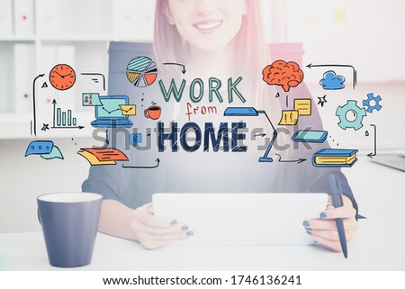 Cheerful young businesswoman using table in blurry home office with double exposure of colorful work from home sketch. Concept of distant work and technology. Toned image