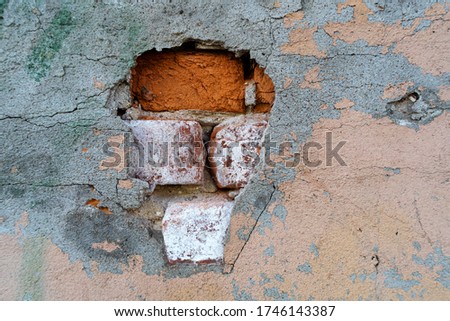 Gray cracked cement plaster of an old brick wall. Industrial architectural background for graphics and design