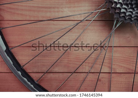 Close up bicycle parts on a red wooden background. 