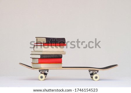 School books on a skateboard