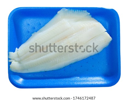 Top view of fresh raw Atlantic halibut fillet on blue plastic tray. Seafood delicacy. Isolated over white background