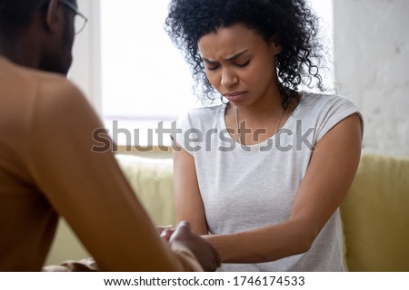 Infertility of spouse, health problem, unplanned pregnancy husband convinces wife to have abortion decision. Break up divorce honest talk between people. African woman receiving moral support concept Royalty-Free Stock Photo #1746174533