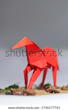 Origami Concept.  Origami Paper horse. with front view in focus and back out-of-focus. Bokeh effect. 
 