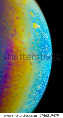 iridescent rainbow on the surface of a soap bubble sphere