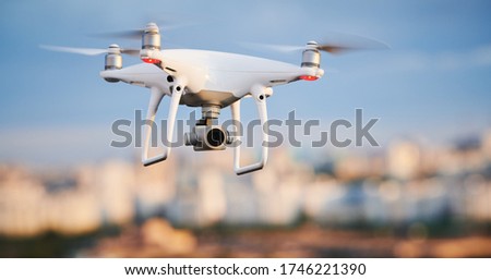 drone with digital camera flying at city street Royalty-Free Stock Photo #1746221390