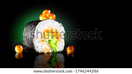 Sushi roll japanese food over black background. Sushi roll with tuna, vegetables, flying fish roe and caviar closeup. Japan restaurant menu. Wide screen