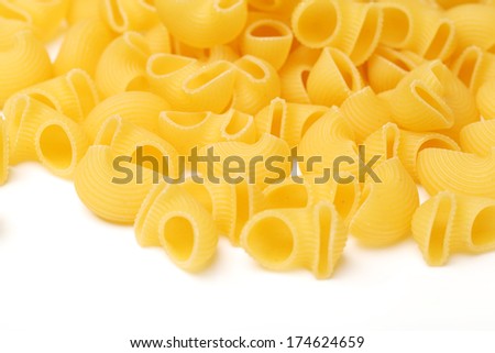 Italian pasta (Gomiti Rigati) on white background 