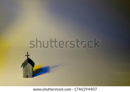 Colorful wooden church with harsh lighting on pastel background. Conceptual about accepting all color