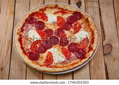 pizza with bacon, salami and mozzarella