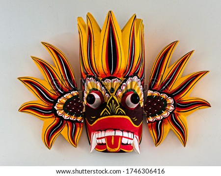 Traditional Ginidella Raksha mask from Sri Lanka. The purpose of the mask is to ward off evil. This mask represents the emotion anger, which is why the colours are red, orange and yellow