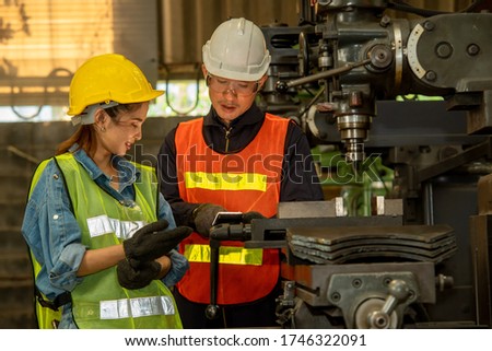 Factory worker and engineer as team working in a factory.