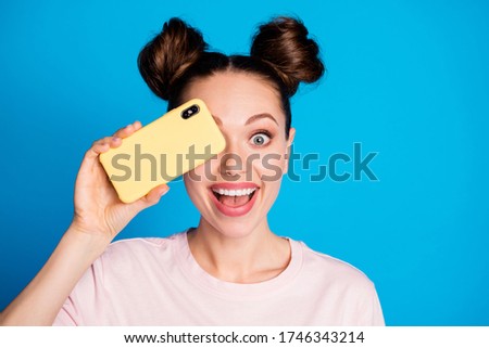 Close-up portrait of her she nice-looking attractive lovely glad cheerful cheery girl closing eye with digital device cell gadget having fun isolated bright vivid shine vibrant blue color background
