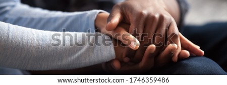 Close up photo african couple in love, woman man holding hands. Gesture of sincere feelings, compassion, apology, reliable friend, share pain or happiness. Horizontal banner for website header design Royalty-Free Stock Photo #1746359486