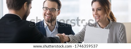 Bank workers and satisfied client make deal shake hands. Signing profitable contract entities business parties congratulates each other handshaking. Horizontal photo banner for website header design