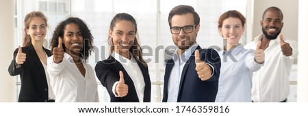 Group of multi ethnic staff standing in row smiling showing thumbs up hand gesture, concept of career success growth, best corporate service feedback. Horizontal photo banner for website header design
