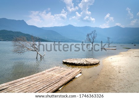 Beautiful pictures of bamboo rafts with dry trees on Lap An lagoon, Hue city, Vietnam