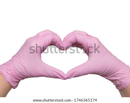 Hands in pink heart-shaped medical gloves, with love to the doctors of the world, isolated on white, copy space