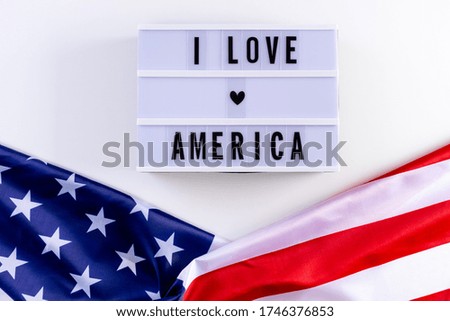 I LOVE AMERICA text in a light box with an American Flag on wthite background. Happy Memorial Day, Independence day, Veterans day. Copy space for advertisers.