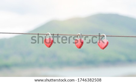 The picture of the red heart hanging on the fence symbolizes eternal love, which hangs during the wedding. Culture and tradition blurred background