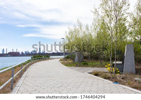 Empty Riverfront at Hunters Point South Park in Long Island City Queens with a view of the Manhattan Skyline along the East River in New York City