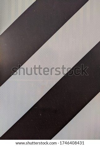 black and white striped road metal sign