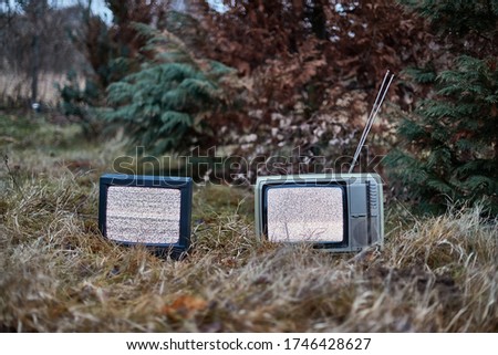 White noise on two analogue TV sets in outdoor environment