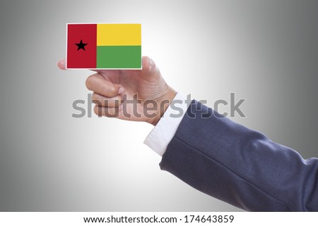 Businessman holding a business card with Guinea Bissau Flag 