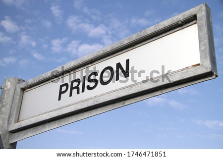 A general view of a Prison directional sign.