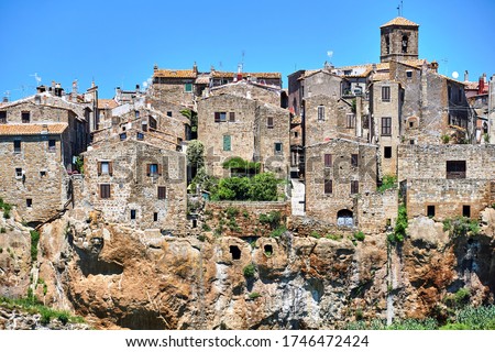 Medieval stone buildings on a rocky cliff in the town of Sorano in Tuscany, Italy
