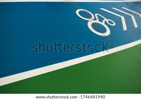 vividful blue color walking path with 
white bike rider sign