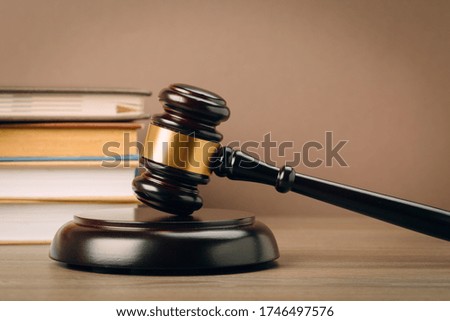 Judge gavel and laws books on a wooden table. The concept of law. sentence, justice