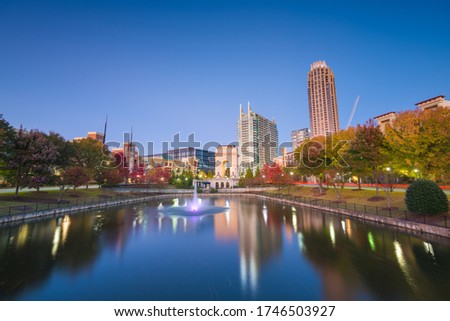 Atlanta, Georgia, USA city skyline from Atlantic Station at dusk with autumn foliage.