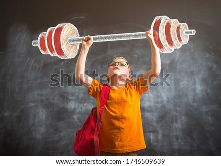 Funny school boy with drawn barbell in hands. Sport and kid concept