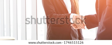 Businessmen and women stood hand in hand to congratulate each other when they joined the office with joy and bright yellow fascism to tell them of their success in the covid scourge.