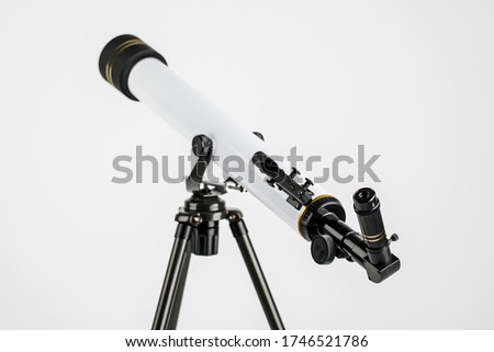 white telescope on tripod isolated on white background