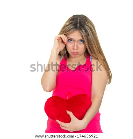 young lonely sad woman holding red valentine heart