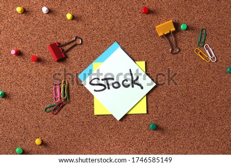 rustic cork board with a stick up note "stock" representing the idea of reminding about stock 