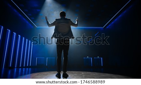 Famous Entertainer Gets on the Stage, Greets Audience, Starts Performance. Software Company Founder, Tech Marketing Guru Making a Pitch, Presentation Speaker Giving Talk. Cinematographic Back View
