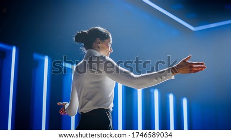 Female Motivational Speaker on Stage, Talking about Happiness, Diversity, Success, Leadership, STEM and How to Be Productive. Woman Presenter Leads Tech Business Conference. Low Angle Shot Royalty-Free Stock Photo #1746589034
