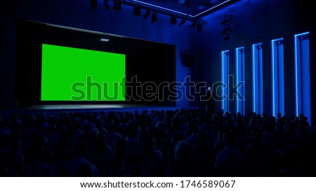In Movie Theater Captivated Audience Watching New Blockbuster Film on Mock-up Green Screen. People Watching Video Game Tournament Streaming, Concert Video, Product Release Trailer.