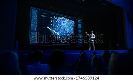 Computer Science Startup Conference: On Stage Speaker Does Presentation of New Product, Talks about Neural Networks, Shows New AI, Big Data and Machine Learning App on Big Screen. Live Event Royalty-Free Stock Photo #1746589124