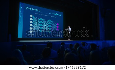 Computer Science Startup Conference: On Stage Speaker Does Presentation of New Product, Talks about Deep Learning, Shows New AI, Big Data and Machine Learning App on Big Screen. Live Event