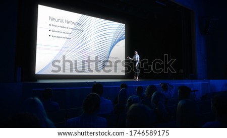 Computer Science Startup Conference: On Stage Speaker Does Presentation of New Product, Talks about Neural Networks, Shows New AI, Big Data and Machine Learning App on Big Screen. Live Event Royalty-Free Stock Photo #1746589175
