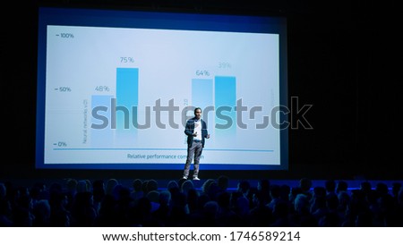 Startup Conference Stage: Speaker Presents New Product, Talks about Performance, Neural Networks, Artificial Intelligence, Big Data and Machine Learning. Live Event with Large Audience Royalty-Free Stock Photo #1746589214