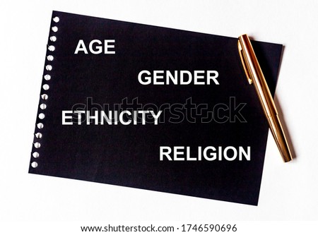 AGE GENDER ETHNICITY RELIGION words in white letters on black paper with golden pen. Equality diversity concept. Census concept