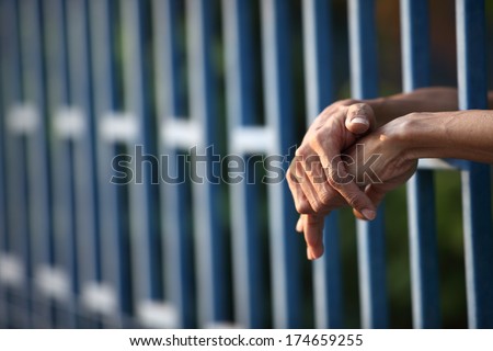 hand in jail. Royalty-Free Stock Photo #174659255